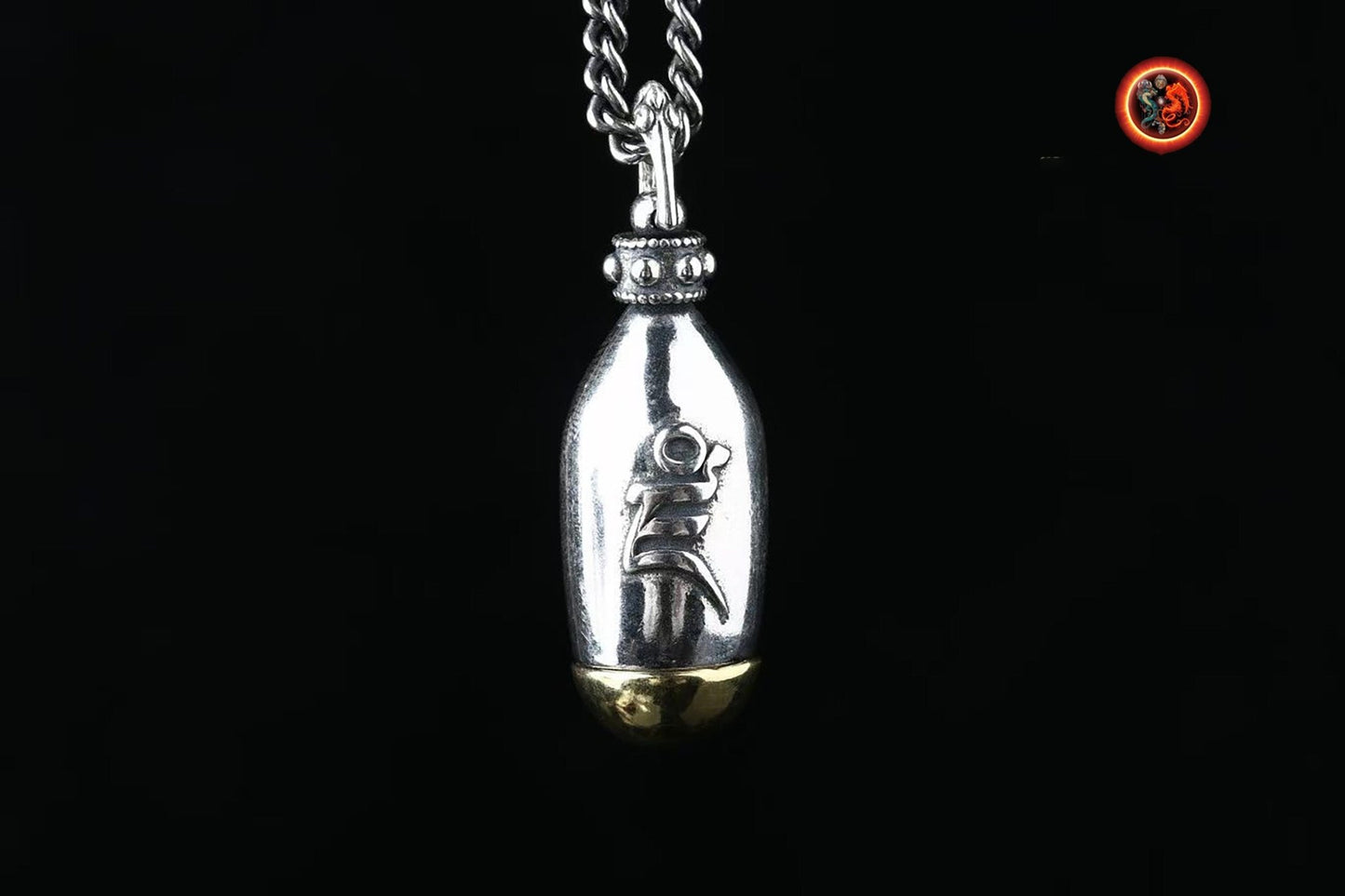 pendentif bouddha, ghau bouddhisme tibetain. Jambhala sous sa forme jaune. Déité de la richesse. mantra syllabe "DZAM" argent 925 et cuivre - obsidian dragon