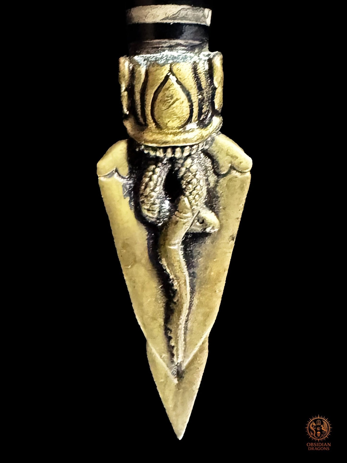 Troisième face de la lame en bronze du Phurba tibétain décorée d’un serpent enroulé sculpté en relief