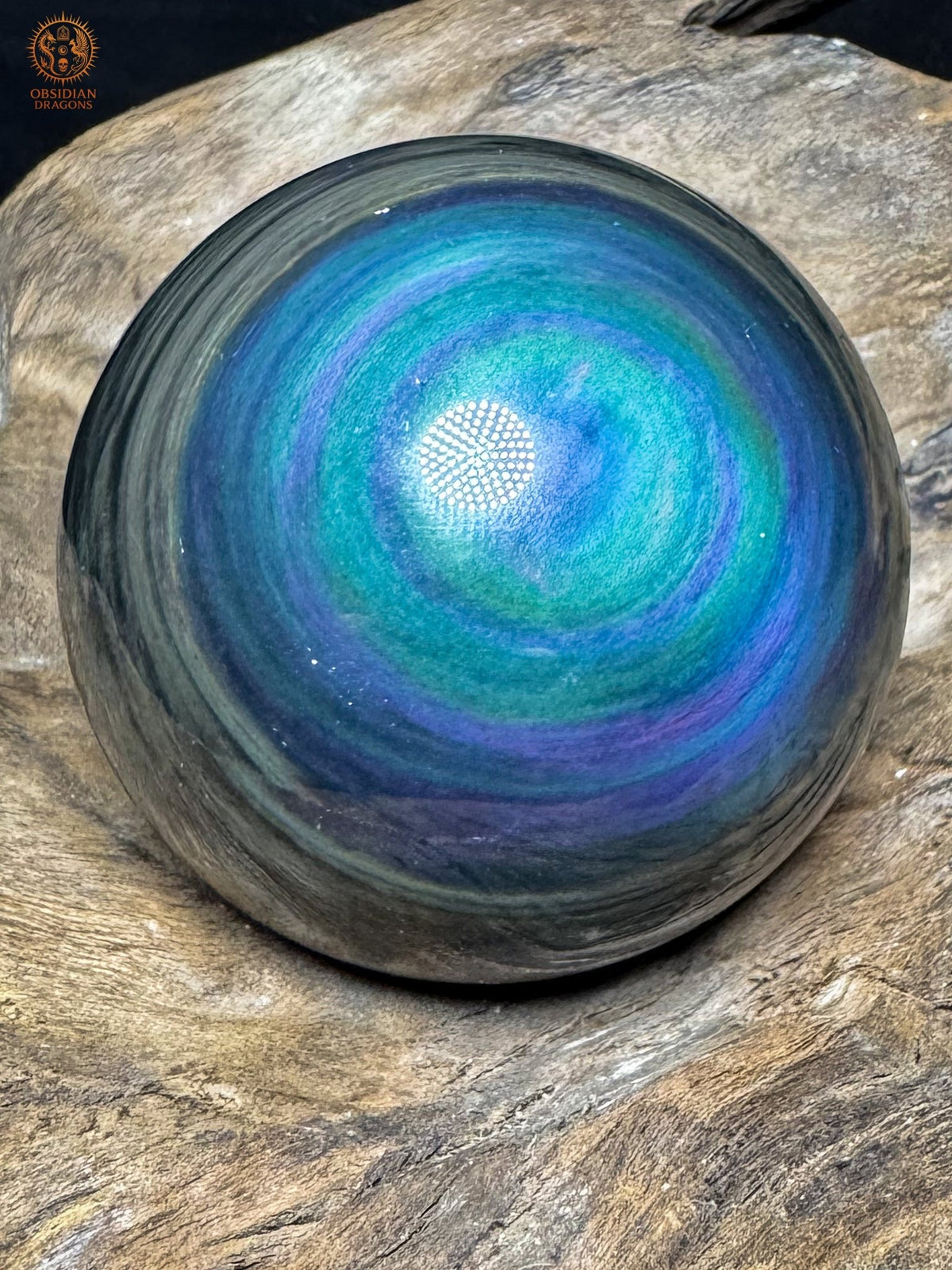 Vue rapprochée de la sphère Manta Huichol, large plage turquoise parcourue de bandes bleues et violettes au dessin panaché.
