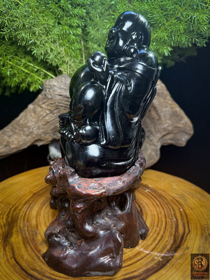 Profil de Budai tourné vers la gauche, Bouddha rieur en obsidienne œil céleste assis sur son sac et présenté sur un socle en cèdre.